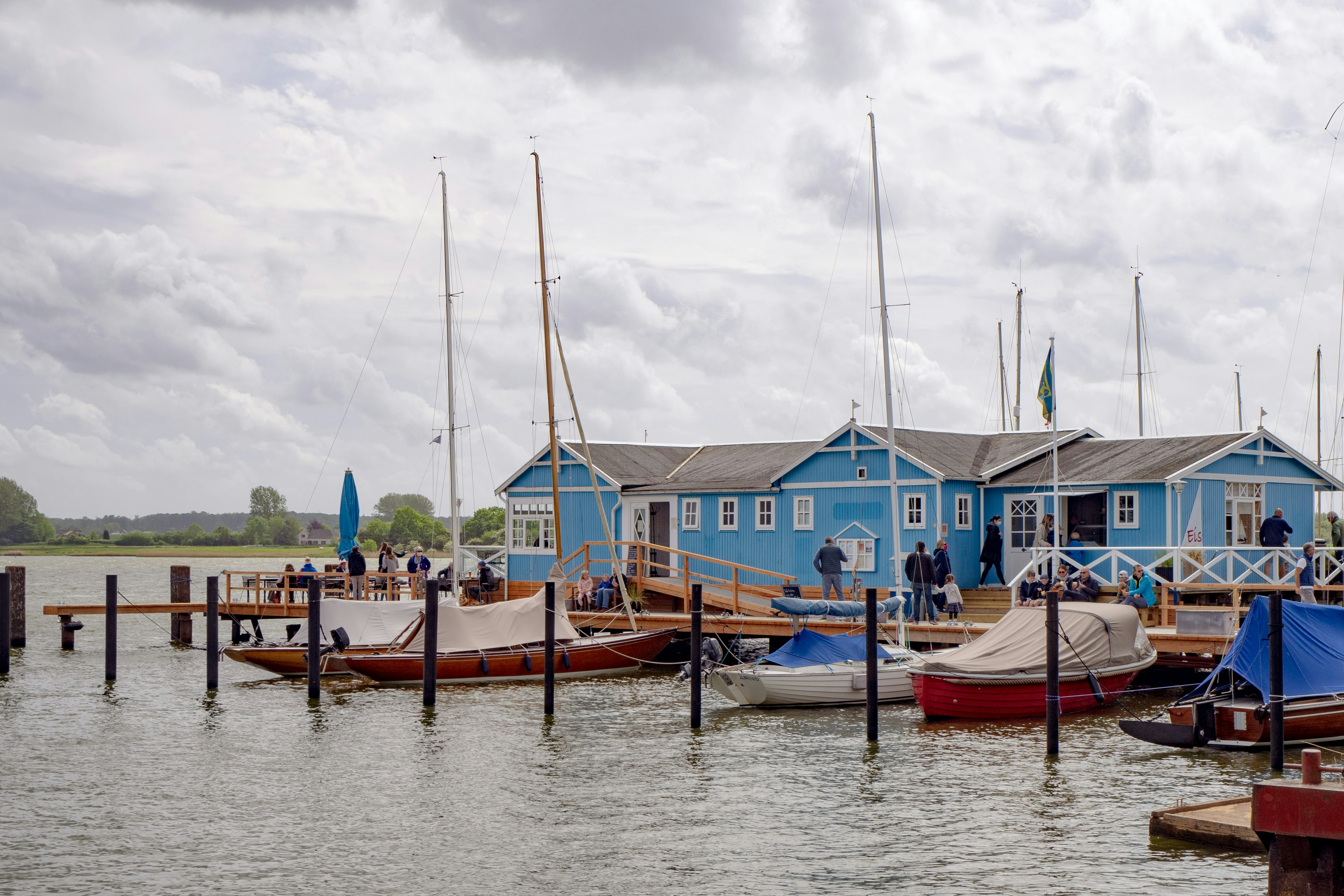 blue and brown boat on water during daytime